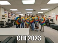 Group of teachers in tie dye shirts in classroom setting.