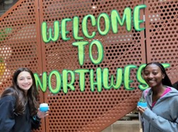 Students in front of "Welcome to Northwest" sign.