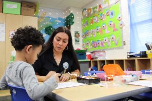 Teaching assistant Marissa Garcia shows students how to complete a math assignment Feb. 12, 2024, at McNutt Elementary. The elementary school offers a pre-K program, a driving factor to attract more students to the district