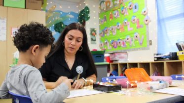 Teaching assistant Marissa Garcia shows students how to complete a math assignment Feb. 12, 2024, at McNutt Elementary. The elementary school offers a pre-K program, a driving factor to attract more students to the district