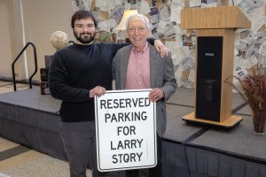 Prof. Story and his grandson pose with his notorious personalized reserved parking sign.