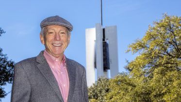 History Professor Larry Story, pictured in front of TCC South's iconic Carillon, retires from Tarrant County College after 58 1/2 semesters.