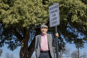 Prof. Larry Story poses had a personal reserved parking sign on TCC South, where he spent his entire 58 1/2 semesters teaching.