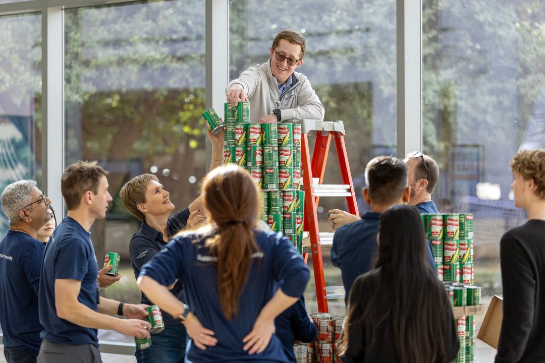 GE Aerospace employees work with TCC students at TCC Trinity River to build structures out of donated canned food.